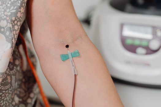 Detailed close-up image of blood being drawn using a needle, suitable for medical contexts.